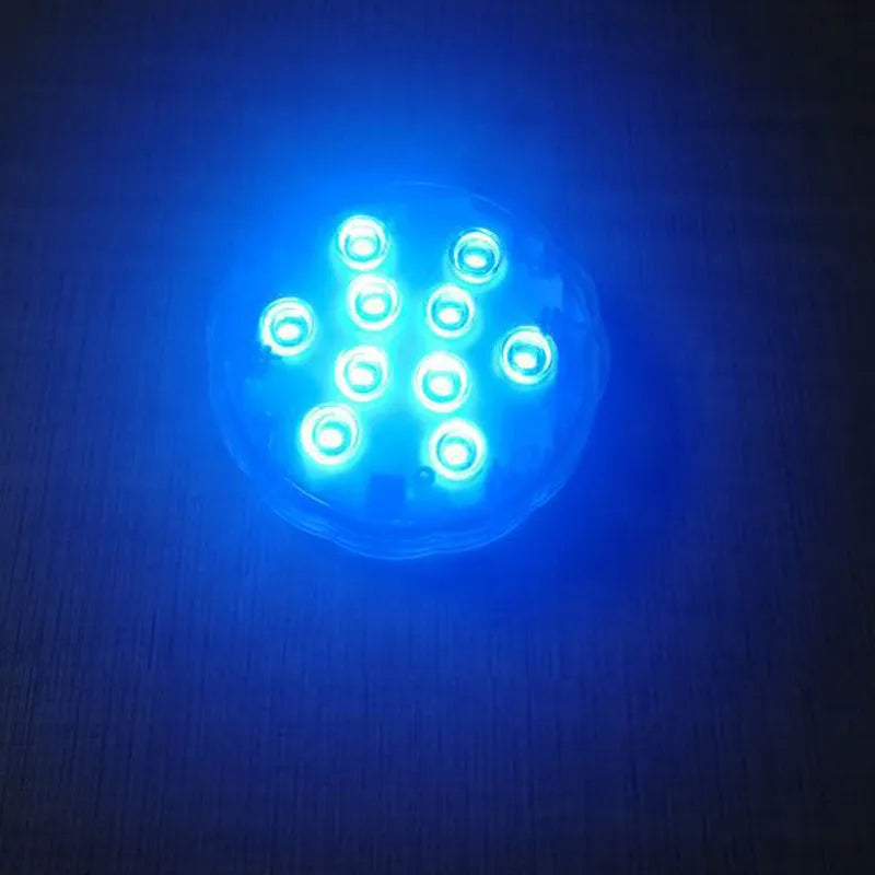 White waterproof LED pool light with remote control on a table
