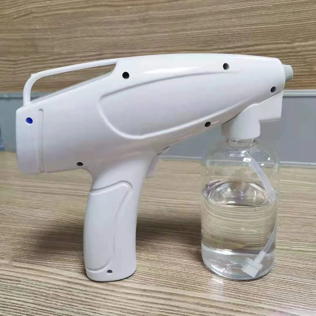 White handheld cordless electric spray disinfection gun with USB charging port.