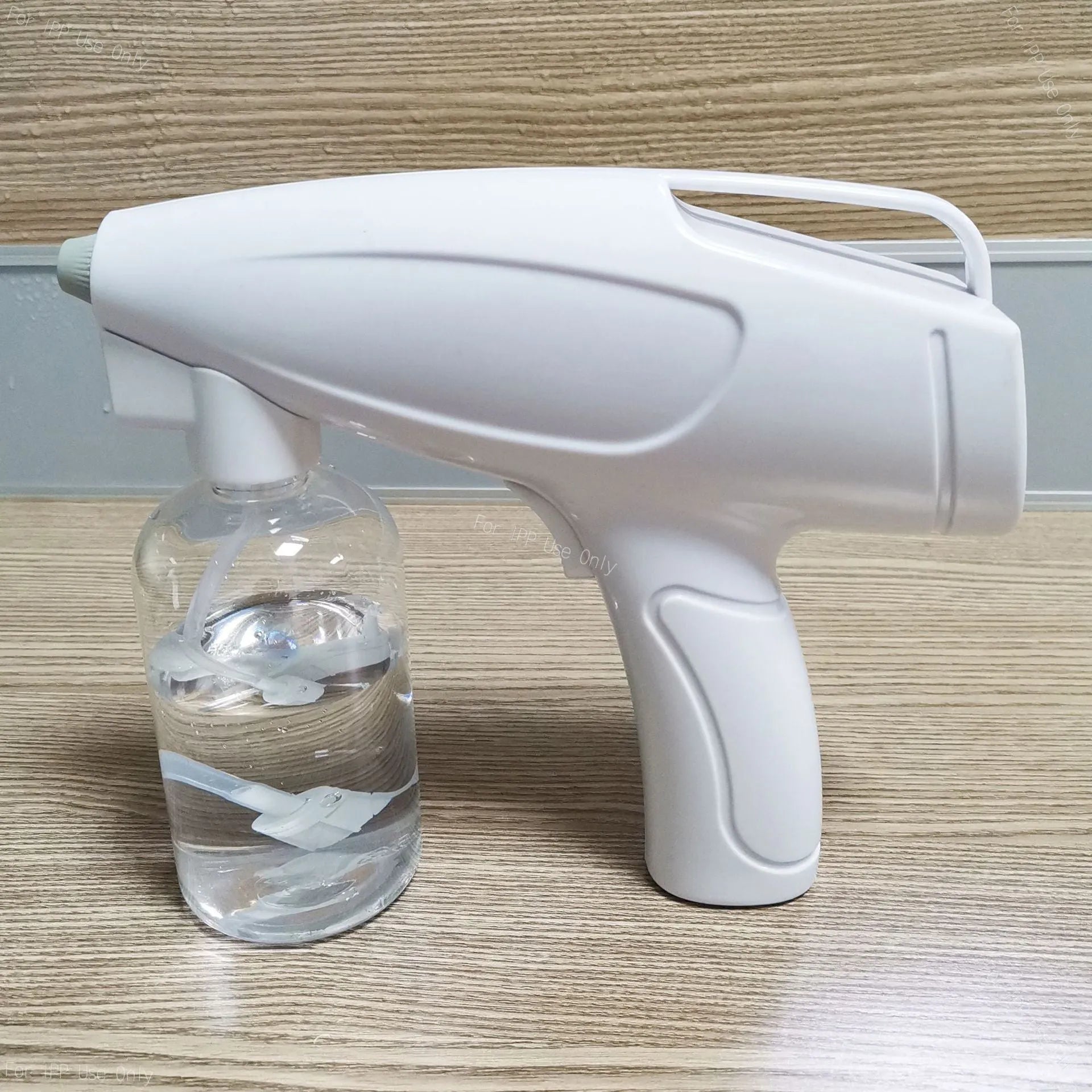White handheld cordless electric spray disinfection gun with USB charging port.