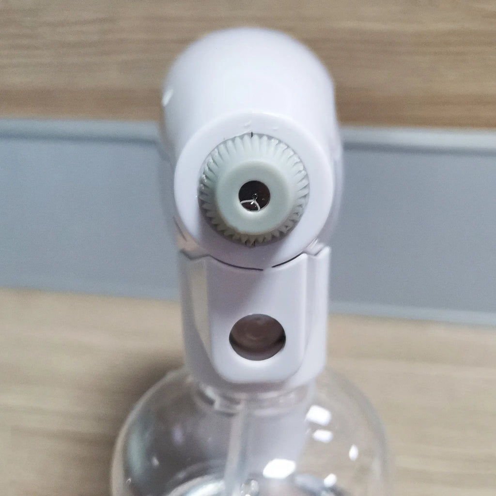 White handheld cordless electric spray disinfection gun with USB charging port.
