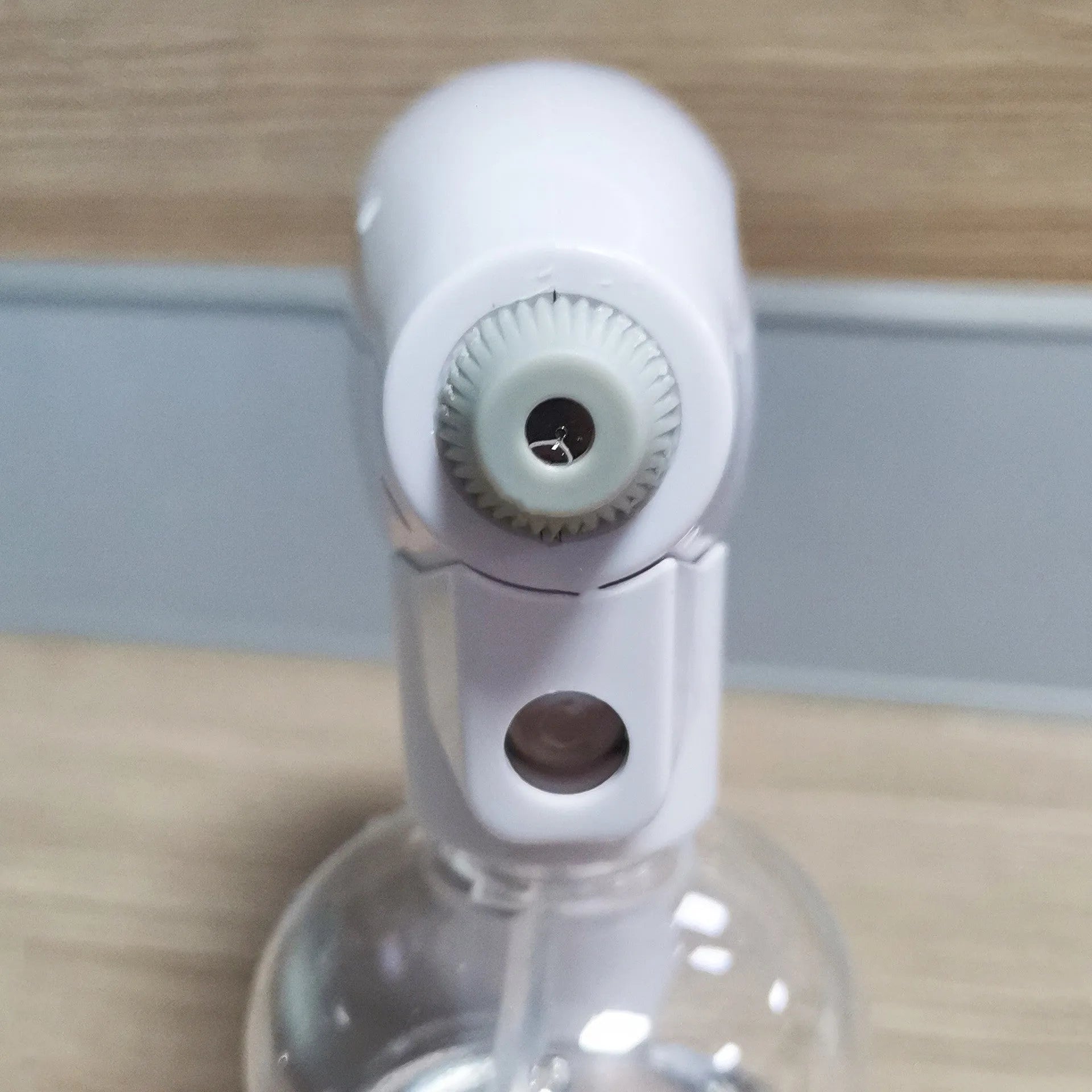 White handheld cordless electric spray disinfection gun with USB charging port.