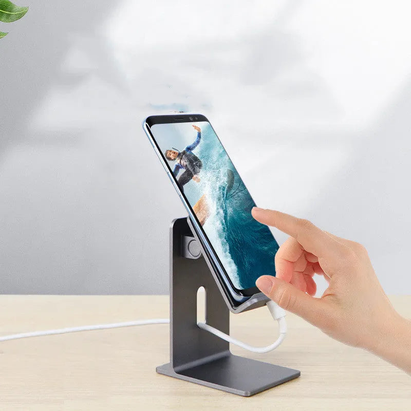 Alloy mobile phone holder bracket in dark space grey colour on a desktop