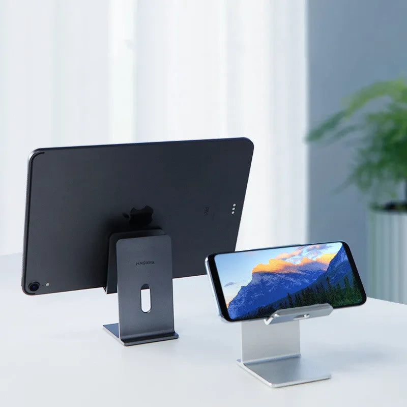 Alloy mobile phone holder bracket in dark space grey colour on a desktop