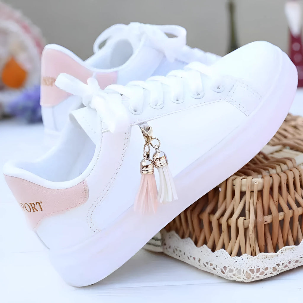 Women's white mesh flat casual trainers with rubber sole on a light background