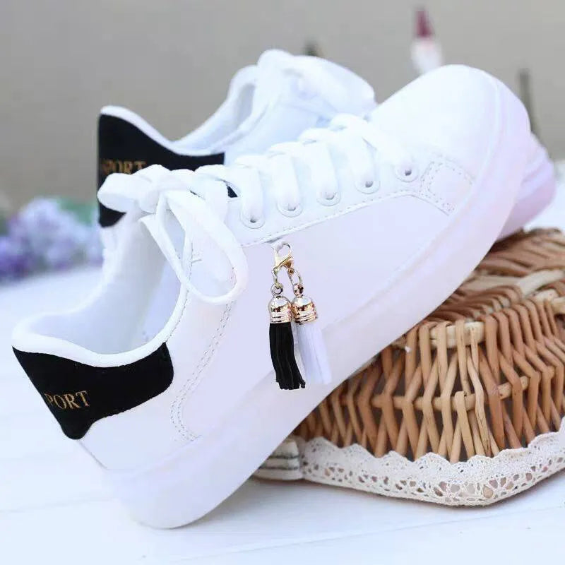Women's white mesh flat casual trainers with rubber sole on a light background