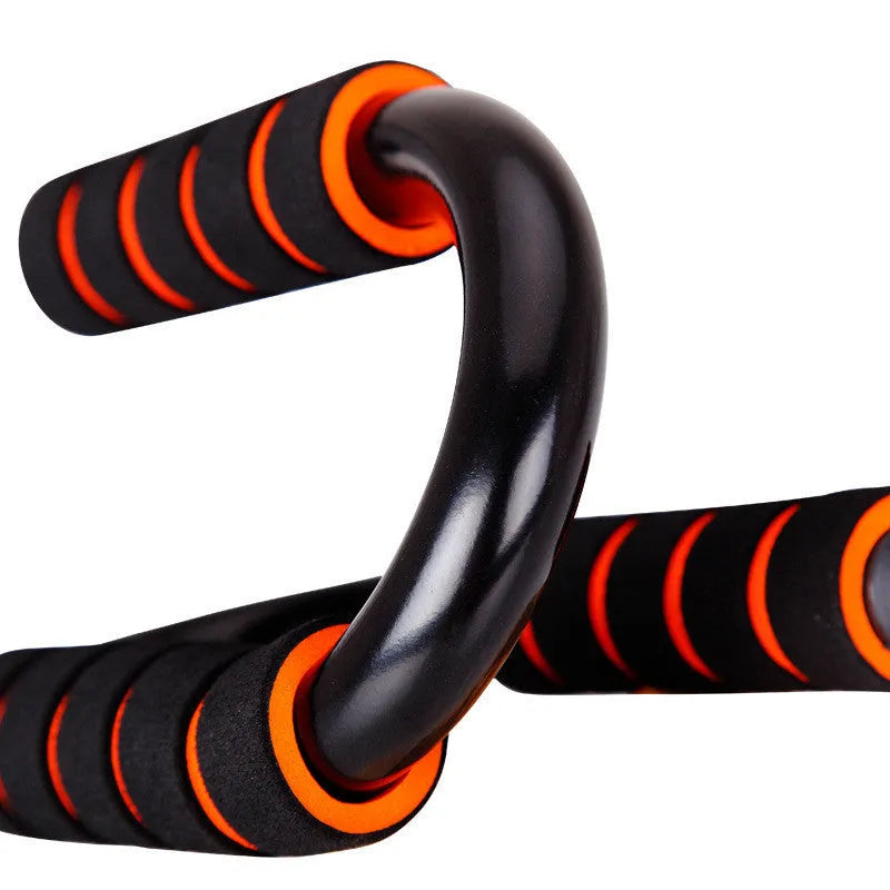 Black steel and foam push-up stand measuring 19x13x13cm on a gym floor