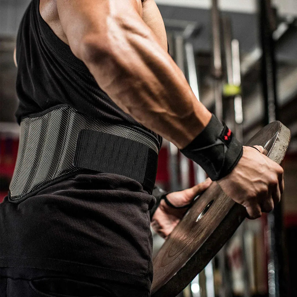 Black nylon squat weightlifting belt with adjustable fastening on a gym floor