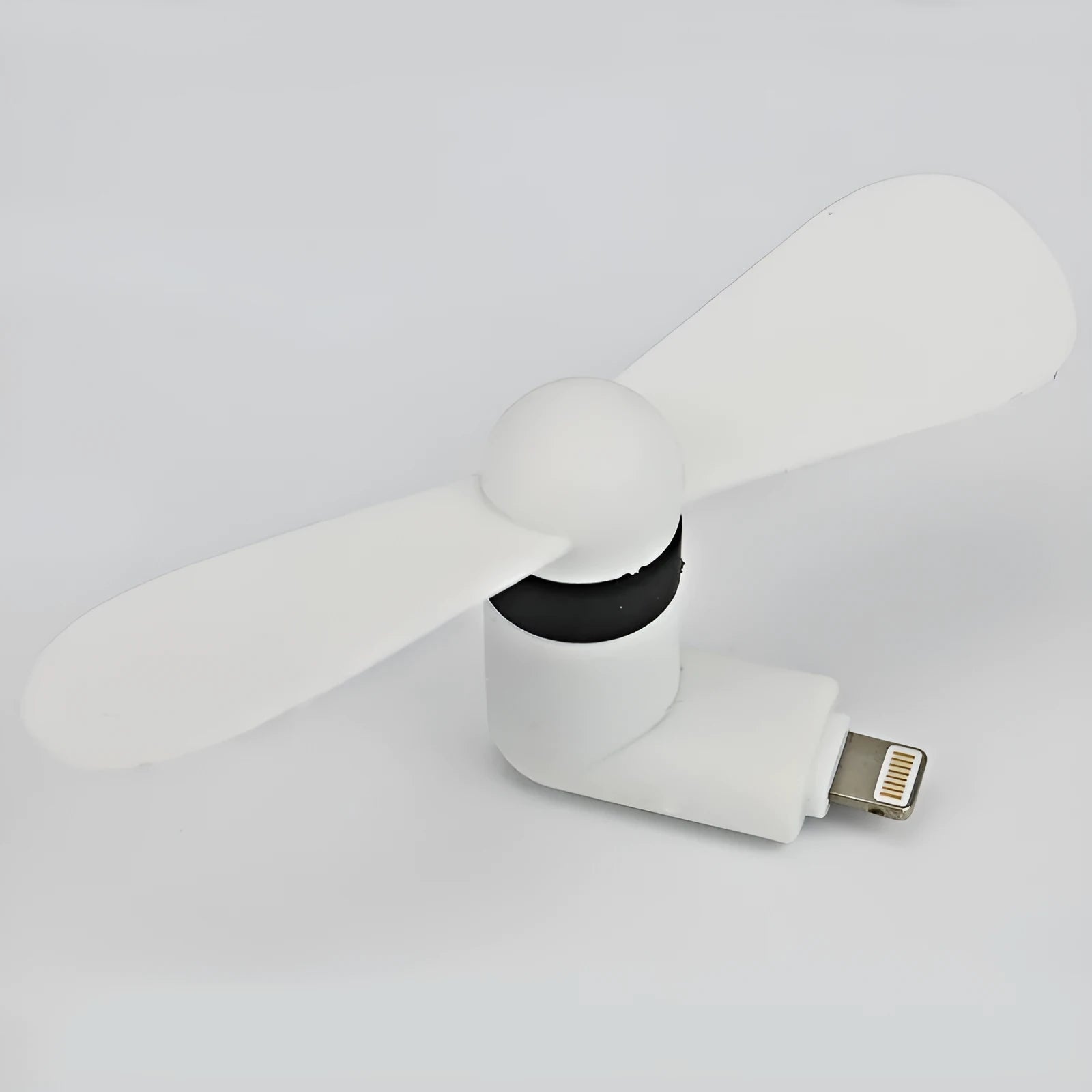 White USB-powered mini personal fan with round plastic blades and a rotary switch, shown next to a mobile phone.