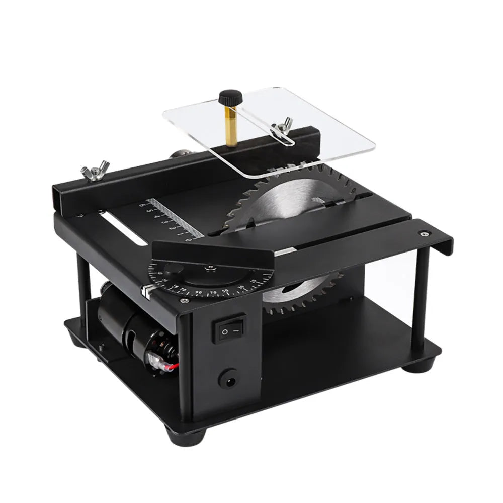 Black miniature precision table saw with sliding table and 110mm blade on a workbench.