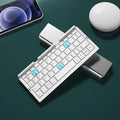 Aluminium folding Bluetooth keyboard in silver white colour showing open typing position and compact folded size