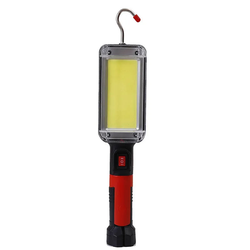Red portable COB LED flashlight with USB cable and magnetic hook on metal surface