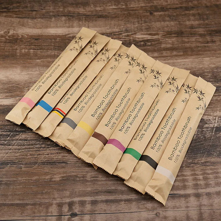 Ten natural bamboo toothbrushes with soft bristles in assorted colours including white, yellow, purple, grey, green and black.