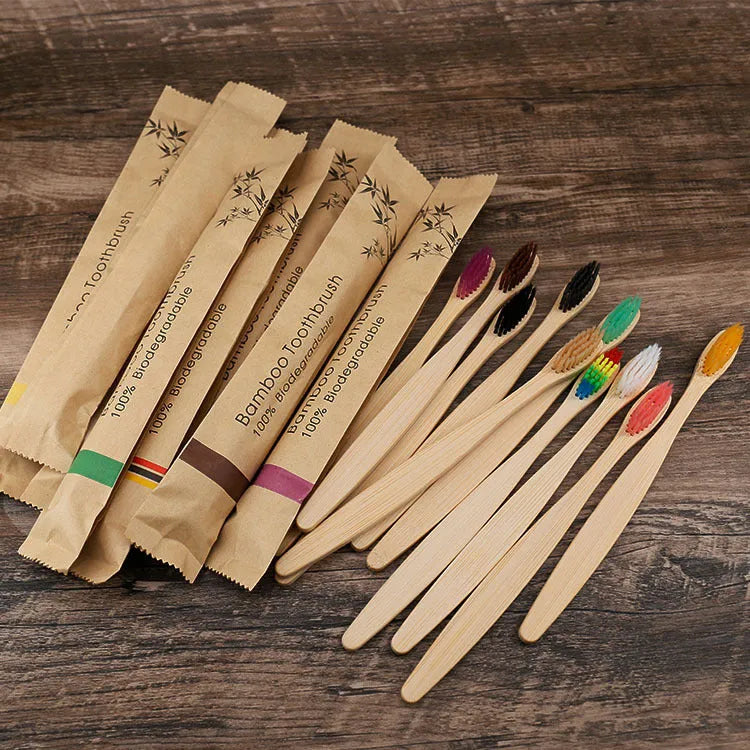 Ten natural bamboo toothbrushes with soft bristles in assorted colours including white, yellow, purple, grey, green and black.