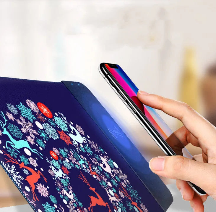 Wireless charging mouse pad with cartoon design and illuminated RGB lighting on desk