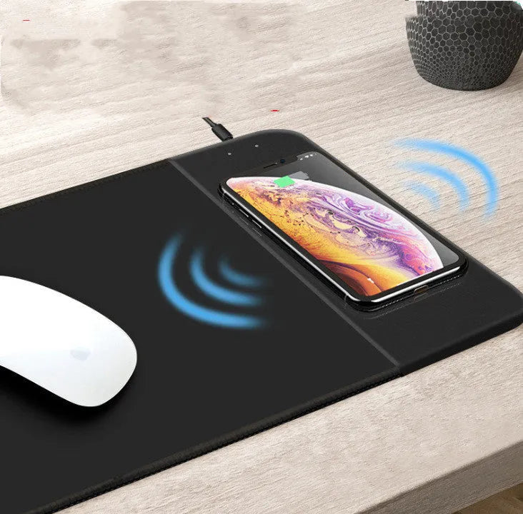 Wireless charging mouse pad with cartoon design and illuminated RGB lighting on desk