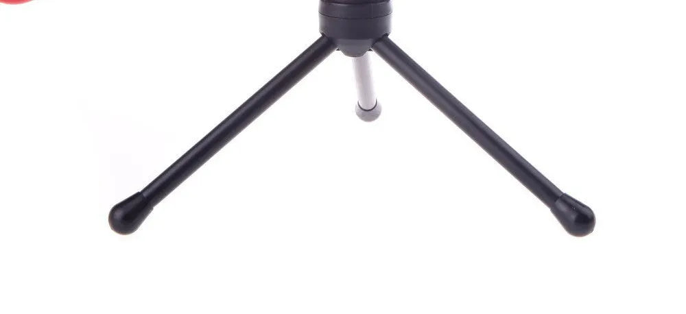 Black wired computer microphone with a detached metal clip holder on a white background.