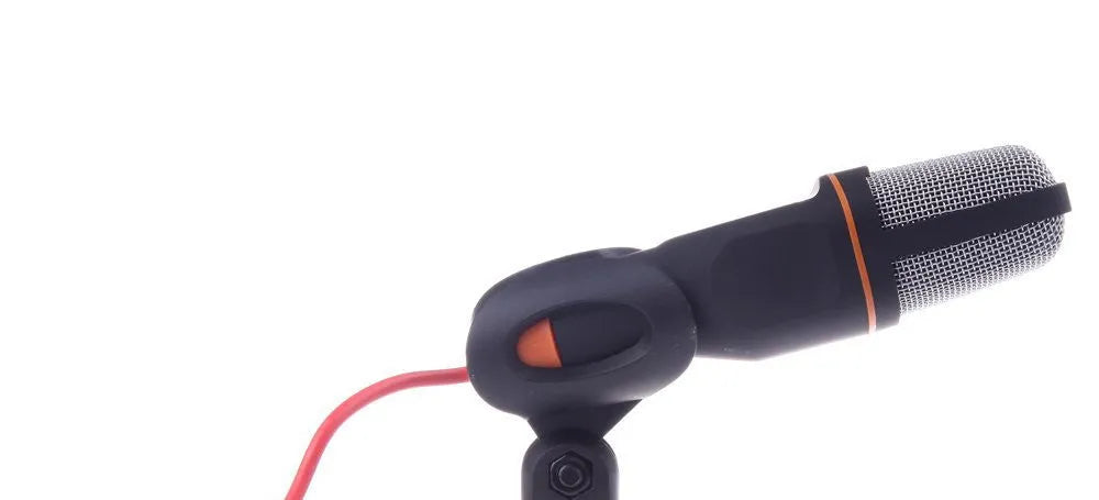 Black wired computer microphone with a detached metal clip holder on a white background.
