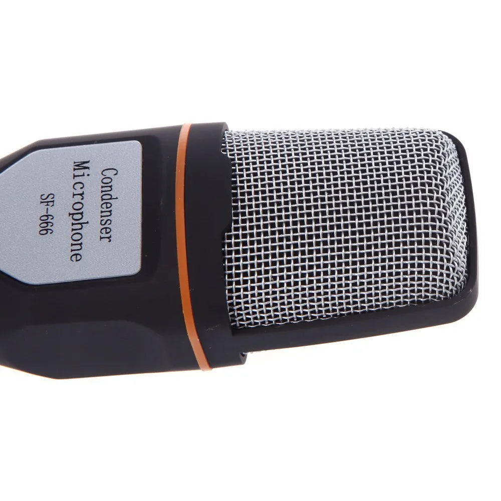 Black wired computer microphone with a detached metal clip holder on a white background.
