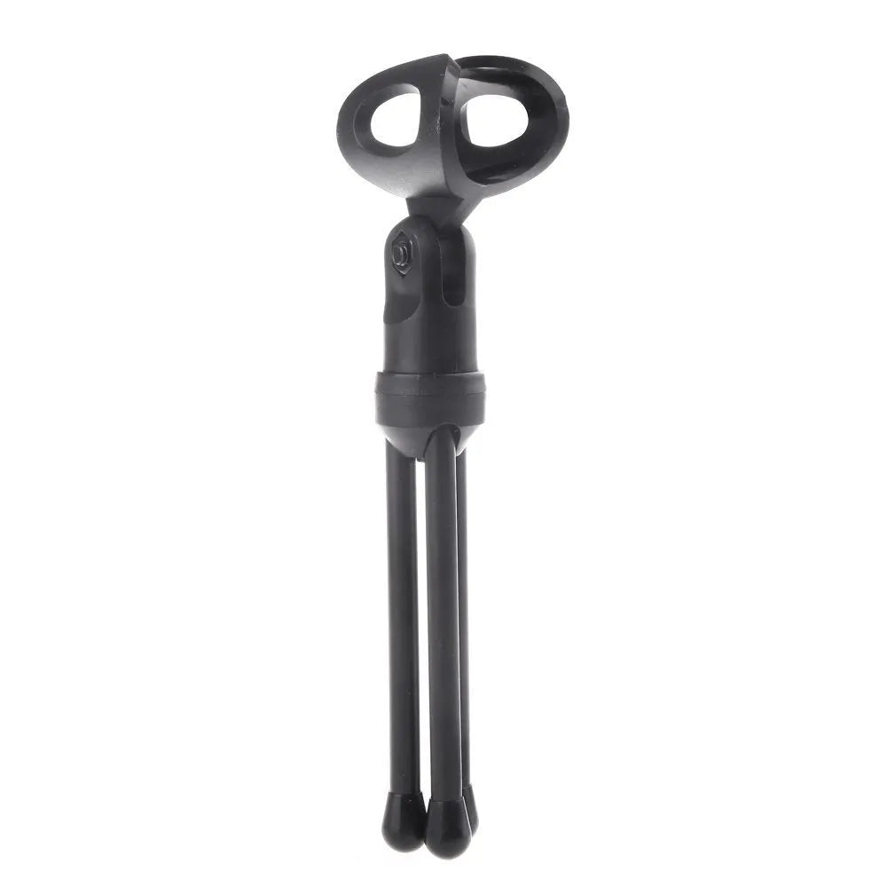 Black wired computer microphone with a detached metal clip holder on a white background.