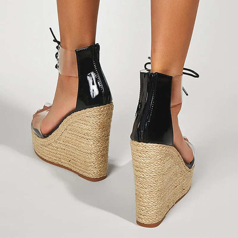 Black women's wedge sandals with hemp rope detail and a high front tie closure on an 8cm platform heel.