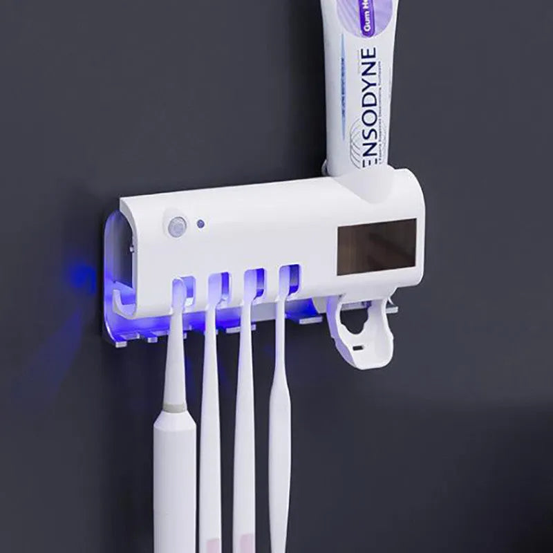 White intelligent wall-mounted UV toothbrush steriliser with automatic toothpaste squeezer unit.
