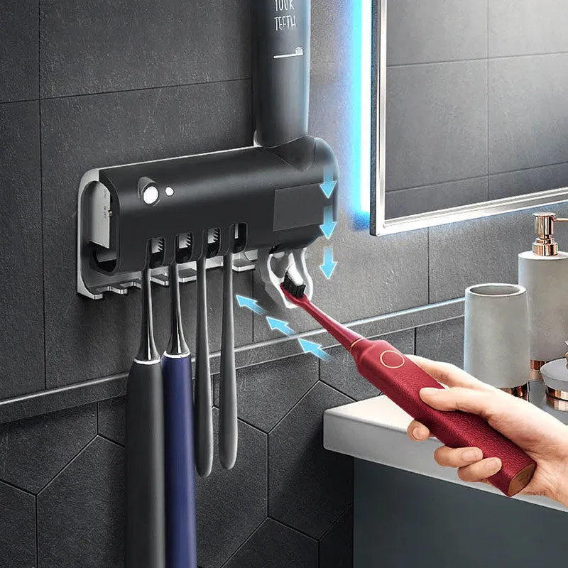 White intelligent wall-mounted UV toothbrush steriliser with automatic toothpaste squeezer unit.