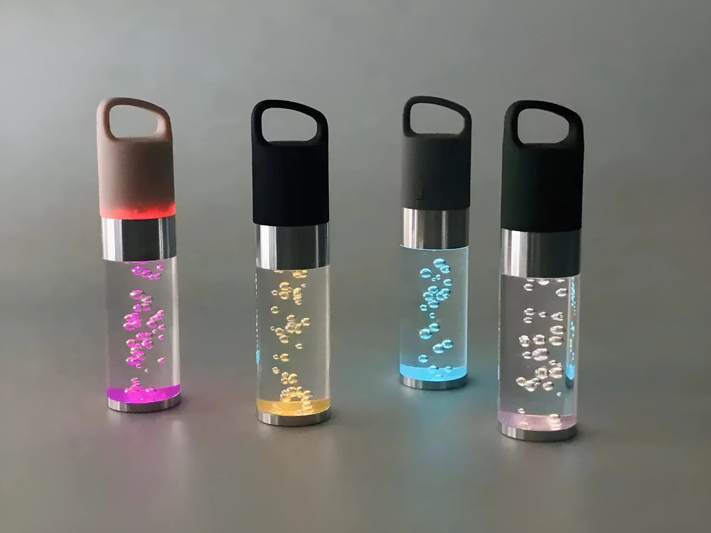 Compact pink portable Bluetooth speaker with colourful crystal light effect on a surface.