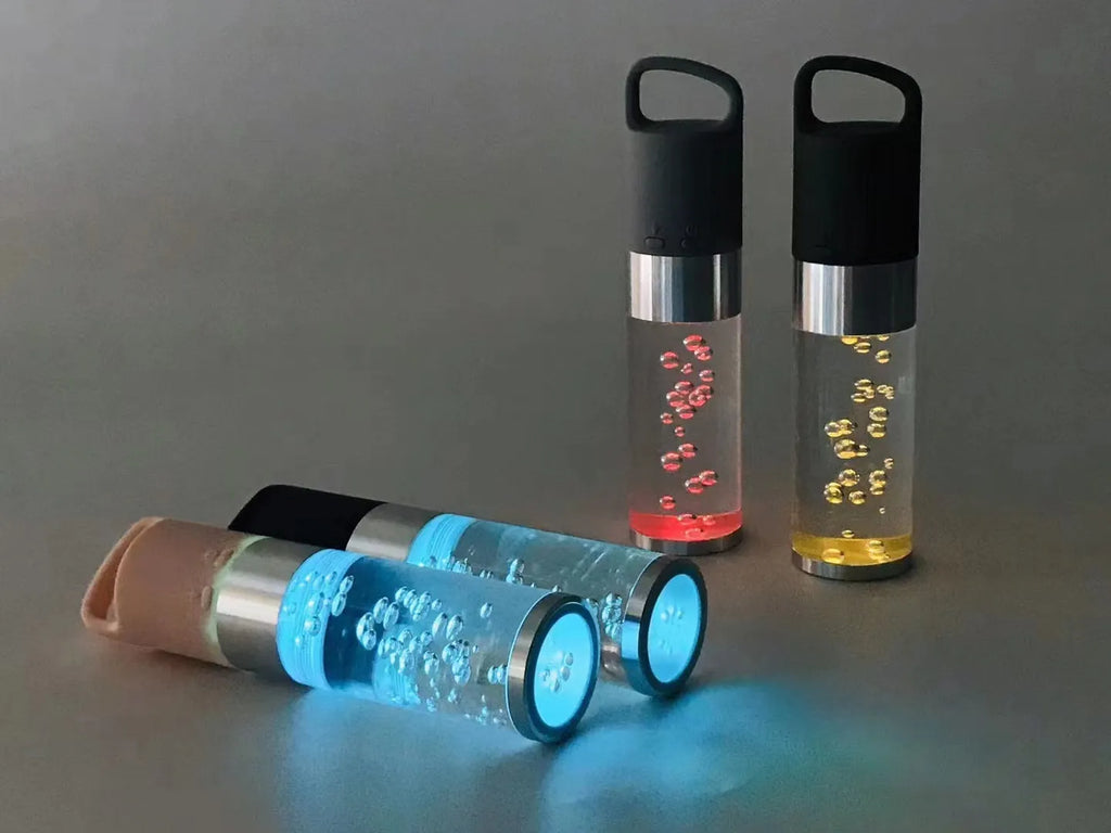 Compact pink portable Bluetooth speaker with colourful crystal light effect on a surface.
