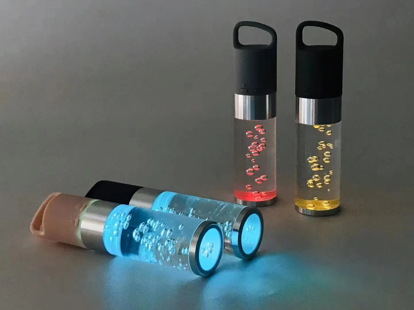 Compact pink portable Bluetooth speaker with colourful crystal light effect on a surface.