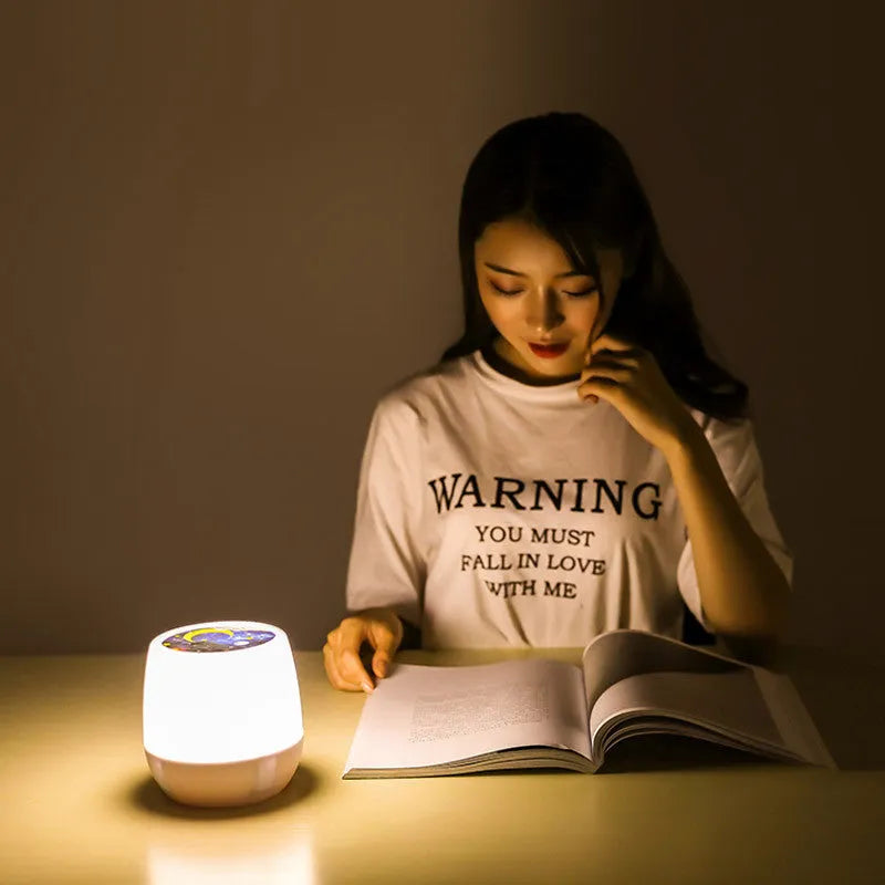 Pruixin LED projector night light projecting rotating star and moon patterns on a bedroom wall.