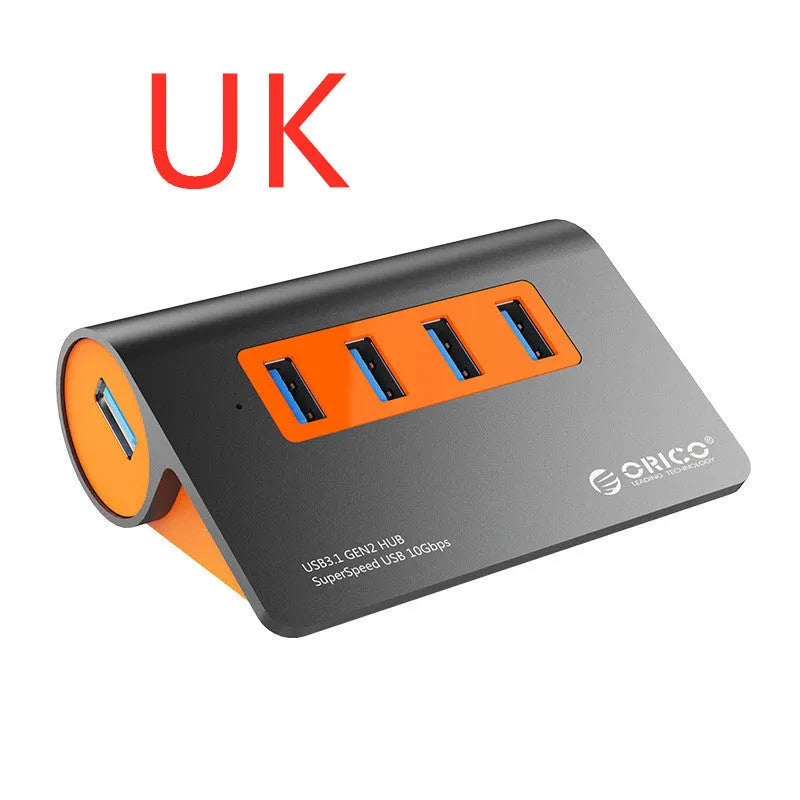 Dark grey aluminium USB hub with four USB 3.1 ports and orange accents, shown with a 100cm data cable.