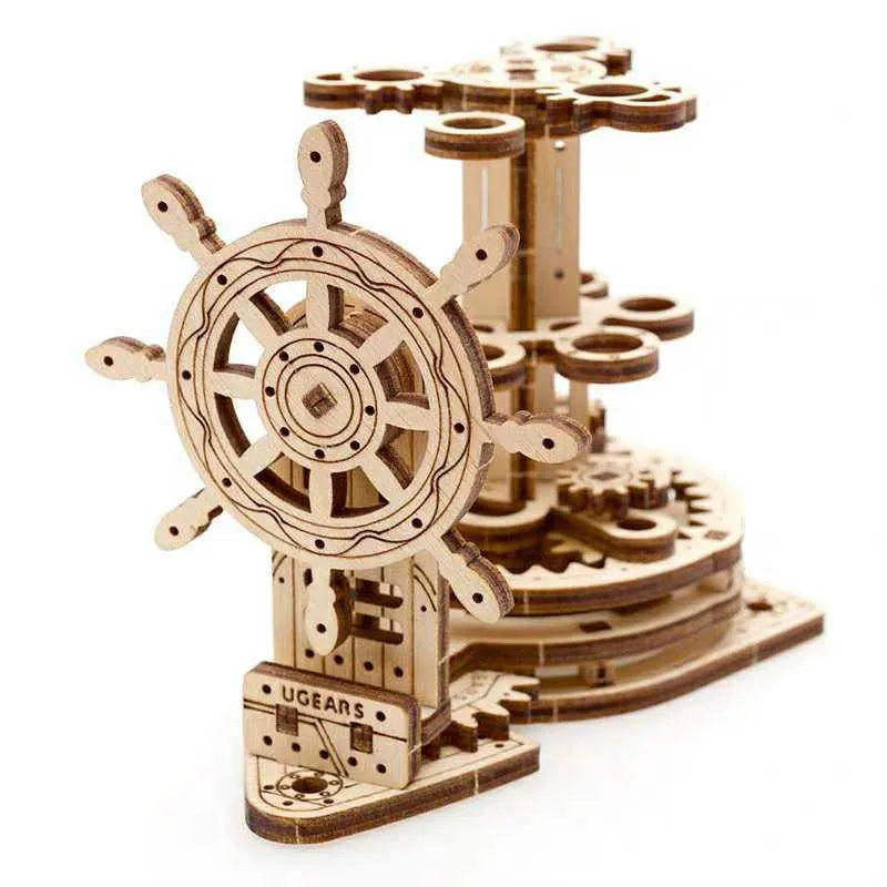 Wooden desk model with a steering wheel that rotates a platform holding pens and pencils.