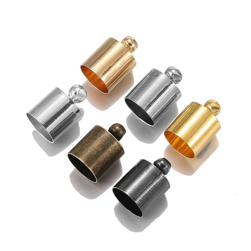 Assortment of electroplated copper bell-shaped tassel caps in various colours and sizes for jewellery making.