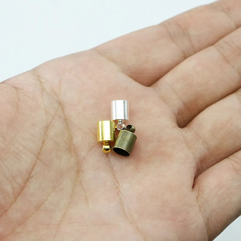 Assortment of electroplated copper bell-shaped tassel caps in various colours and sizes for jewellery making.