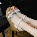 Women's pink wedge sandals with a thick heel, buckle strap, and non-slip sole.