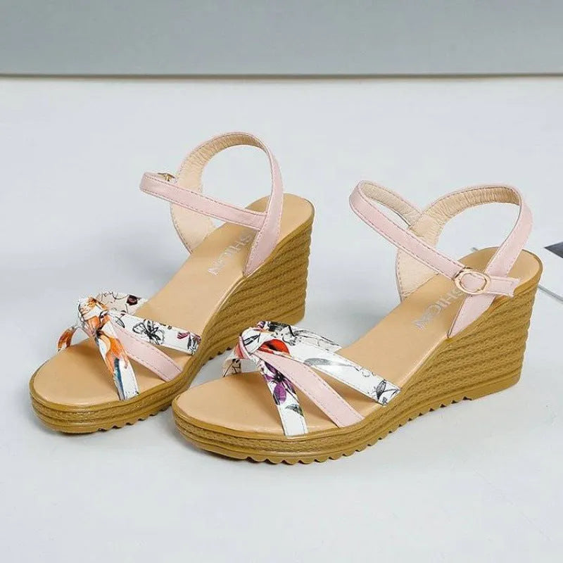 Women's pink wedge sandals with a thick heel, buckle strap, and non-slip sole.