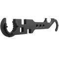 Black all-steel combination wrench for AR15 and M4 rifle maintenance on a workshop bench.