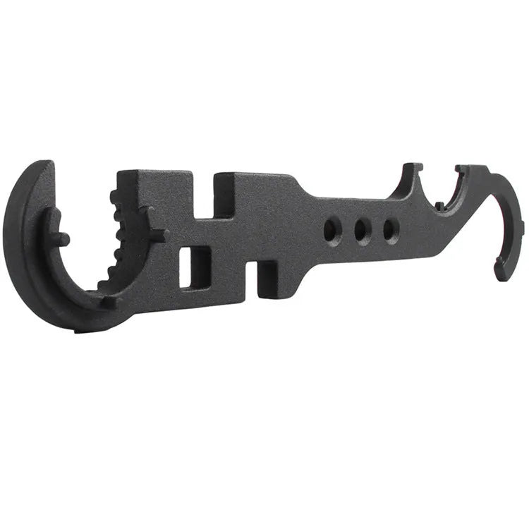 Black all-steel combination wrench for AR15 and M4 rifle maintenance on a workshop bench.