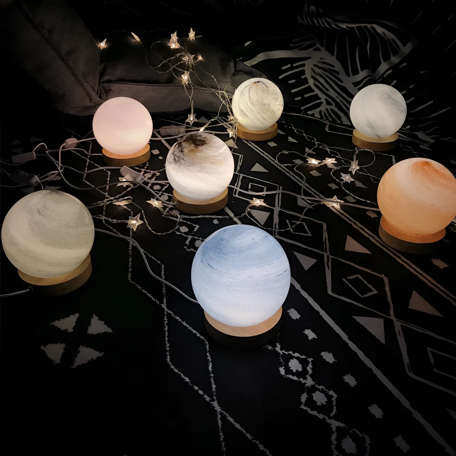 Nordic style USB table lamp with a glass shade shown in one of seven available colours on a bedside table.