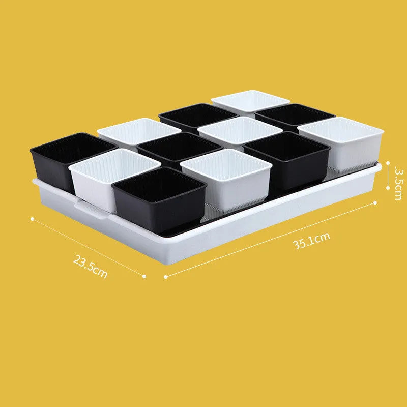 Black and white Meishi resin succulent flower pots with separate trays on a table.