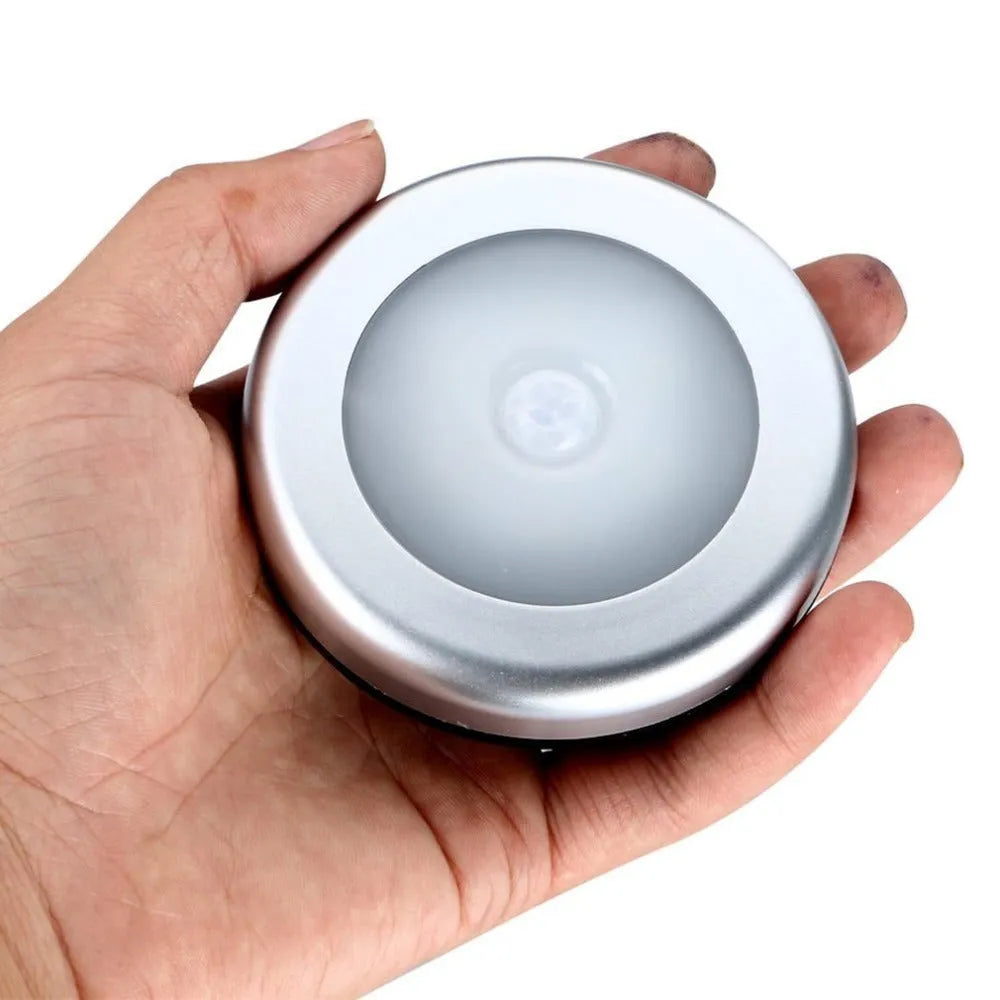 Silver square wireless motion sensor night light for automatic bedside or hallway lighting.