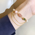 Pink freshwater pearl bracelet with strawberry crystal charms in geometric arrangement