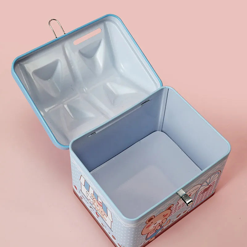 Blue house-shaped tinplate piggy bank for coin storage on a desktop