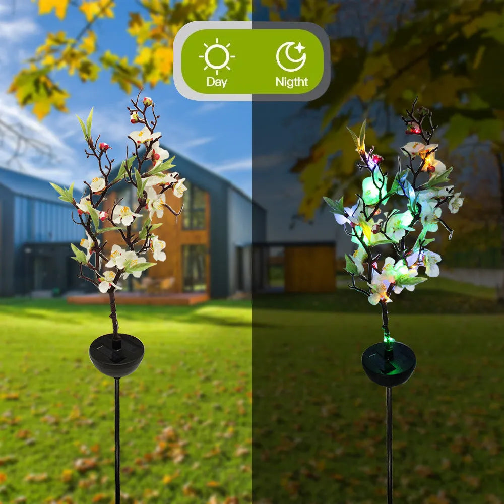 Solar-powered cherry firework string outdoor light with metal ground spike on a lawn.