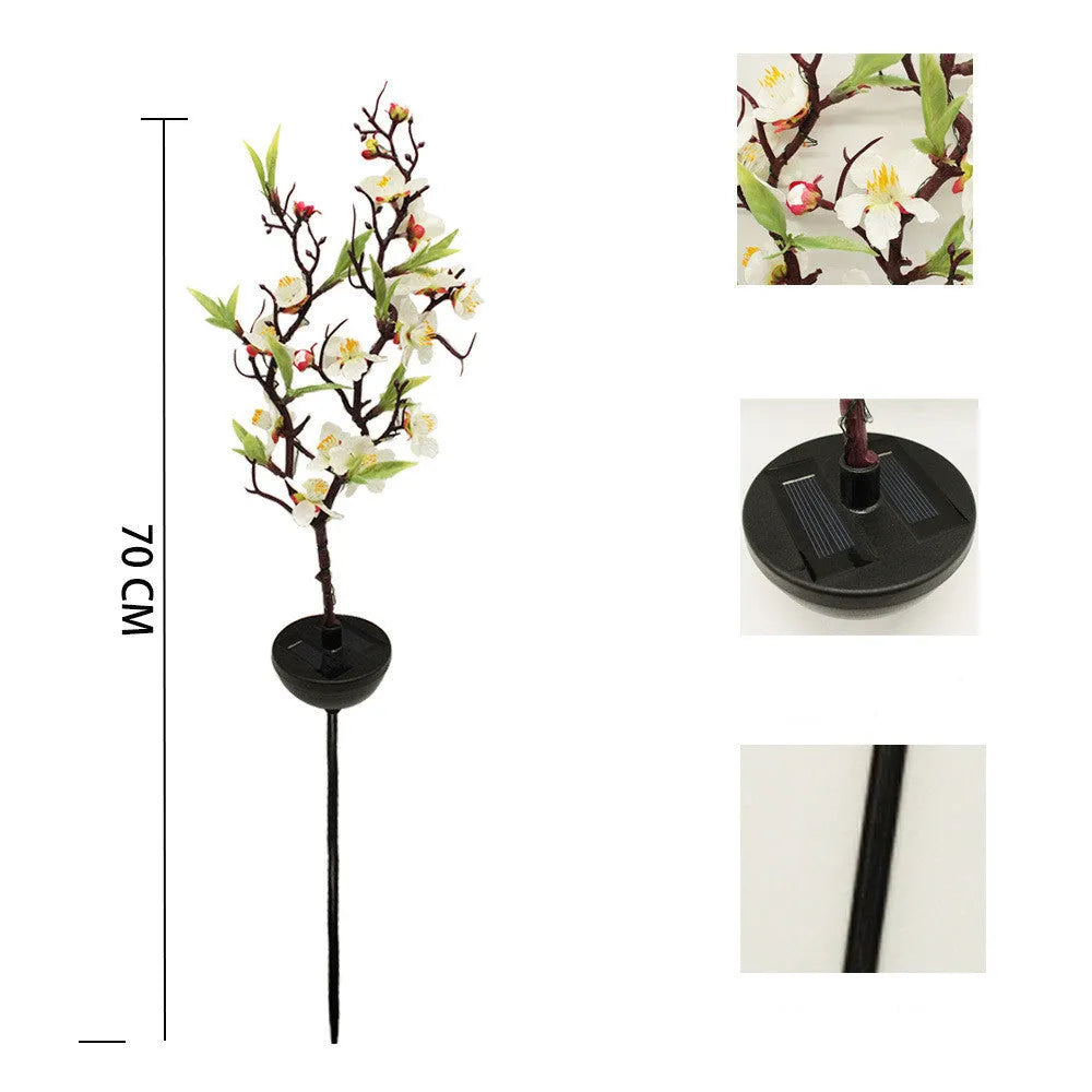 Solar-powered cherry firework string outdoor light with metal ground spike on a lawn.