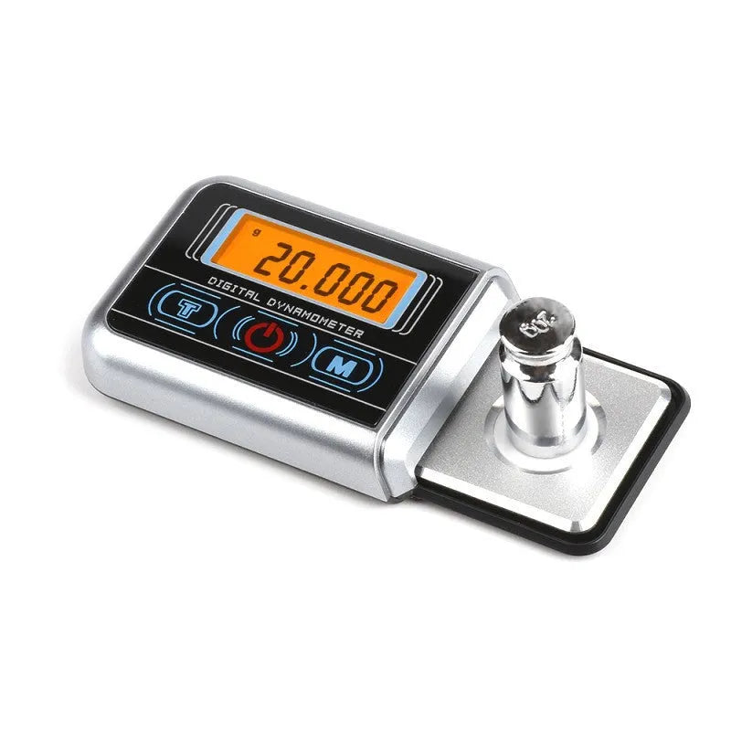 Compact digital electronic scale on a surface, showing a 100g max capacity and 0.005g precision.