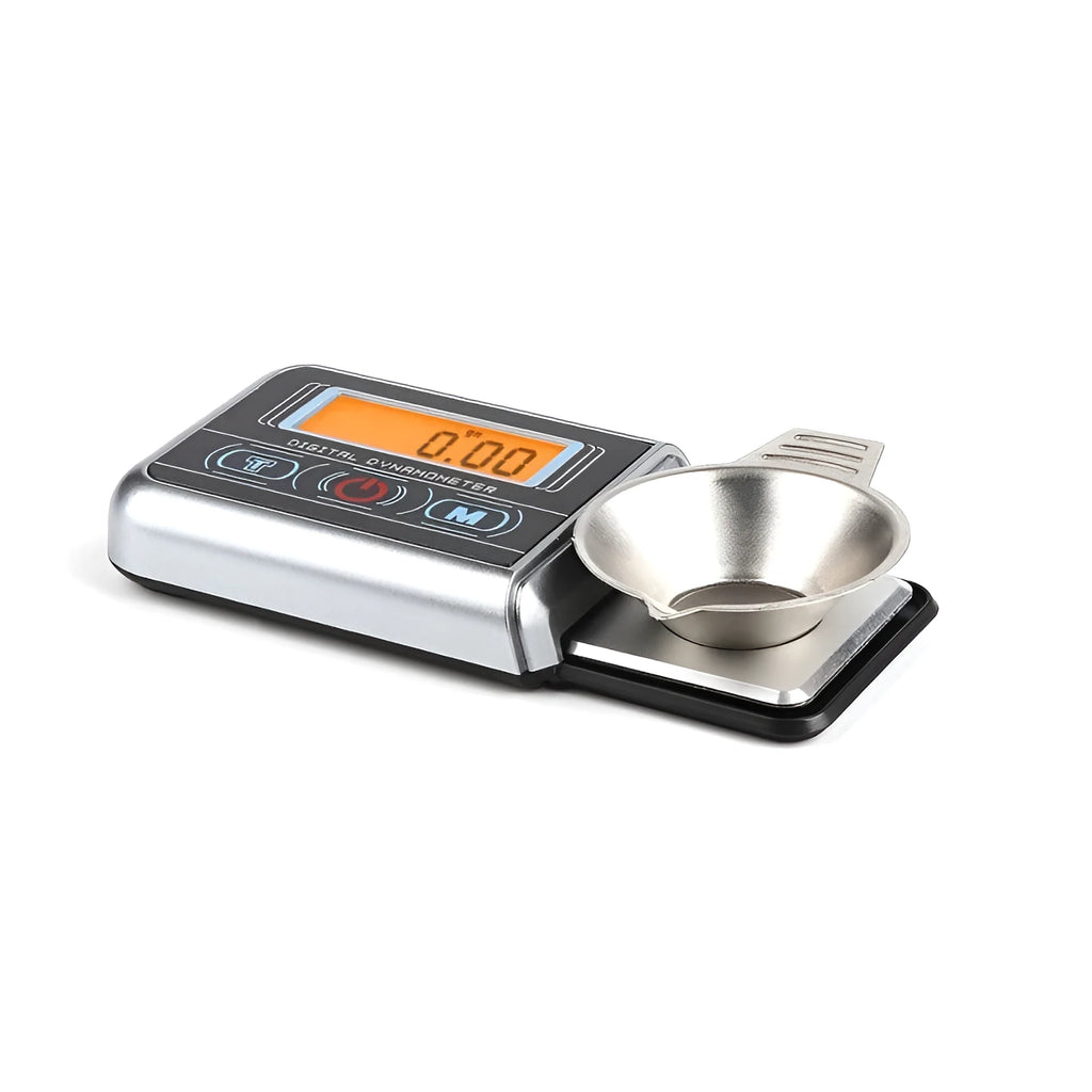 Compact digital electronic scale on a surface, showing a 100g max capacity and 0.005g precision.