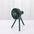 Compact USB desktop fan with flexible black tripod legs and a white fan head on a wooden desk.