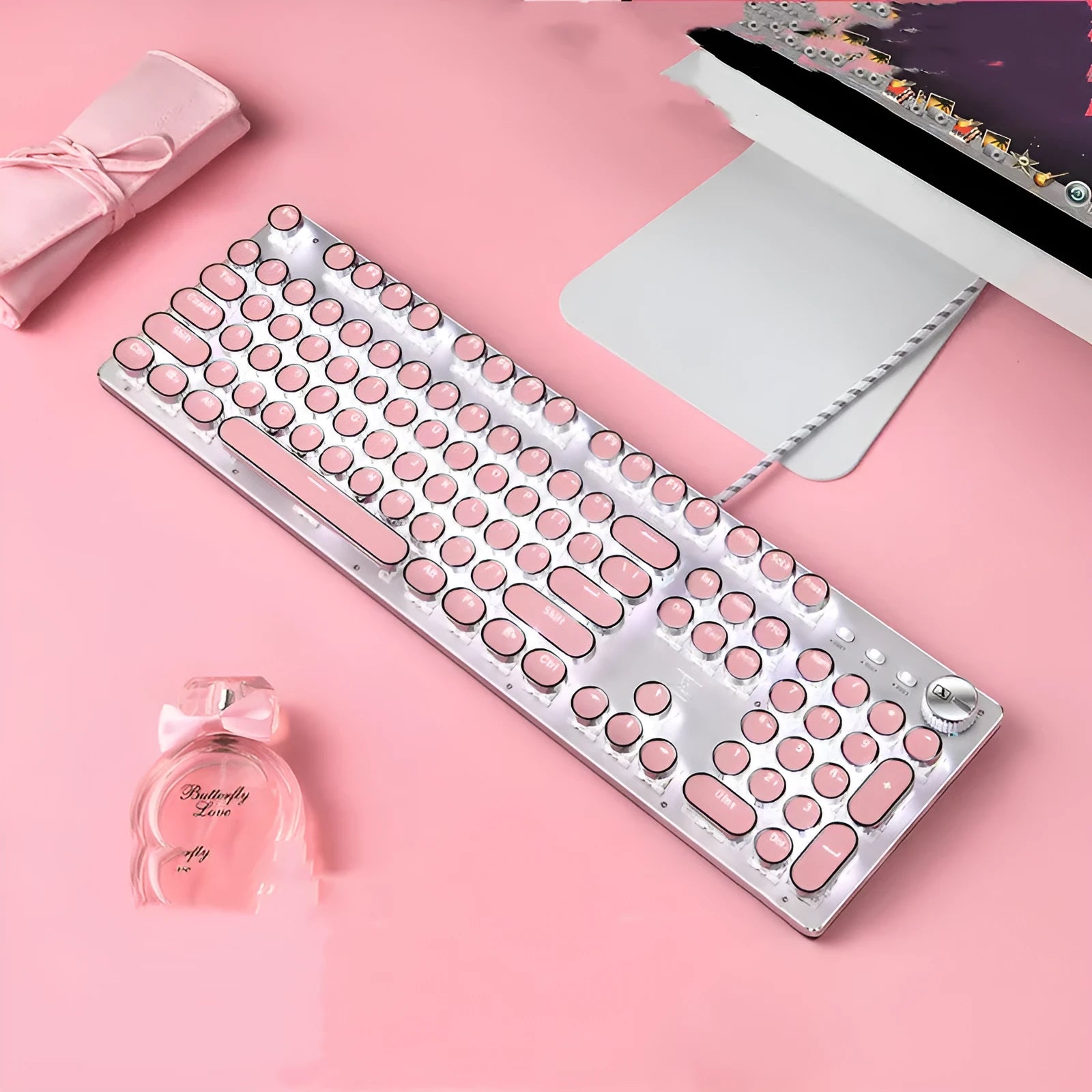 Silver bottom pink mechanical keyboard with white backlight and round keys alongside matching mouse