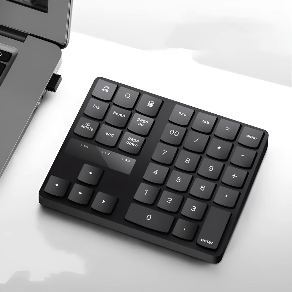 Wireless 35-key numeric keypad in black with USB receiver and charging cable on a desk